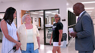  Doctor Watts talks to teachers in the hallway