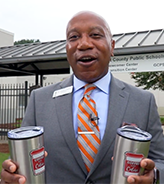  Dr. Watts in front of the international newcomer center with coffee cups