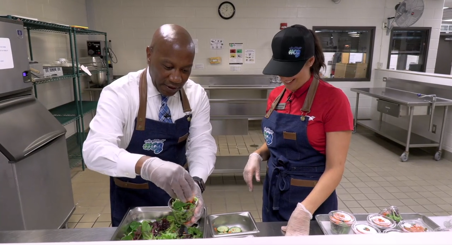   Superintendent Watts working in the cafeteria of Trickum Middle School