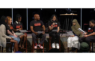  Dr. Watts on stage with GCPS students