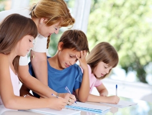 teacher working with three students 