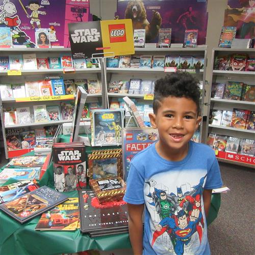 student smiling at book fair 