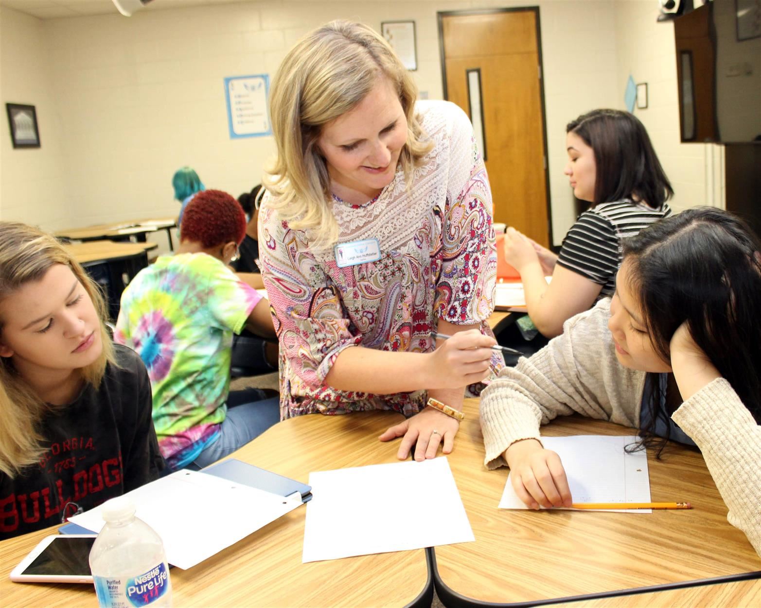 teacher helping students 