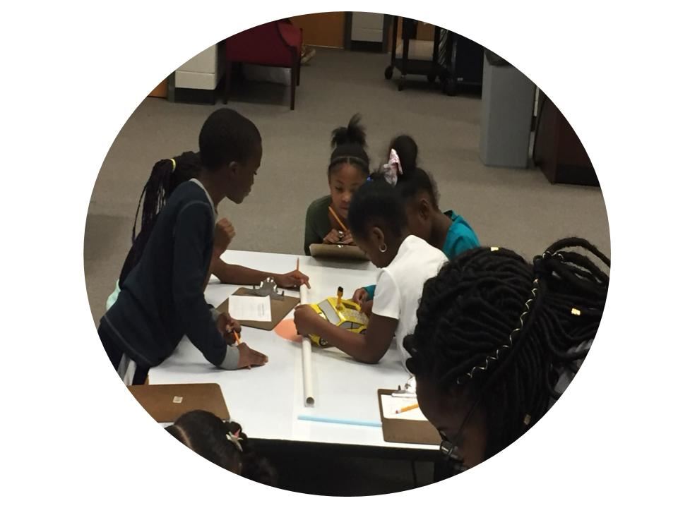 Student measuring with robots